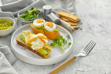 Plate with tasty sandwiches on table