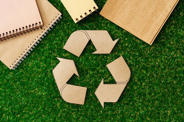 Craft paper on grass, recycling concept, top view