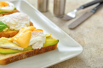 Plate with tasty sandwiches on table, closeup