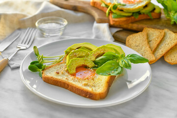 Plate with tasty sandwich on table