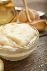 Bowl with garlic sauce on table, closeup