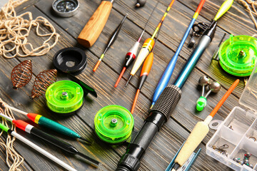 Different fishing equipment on wooden background