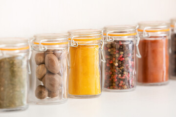 Fototapeta na wymiar Jars with different spices on light background, closeup