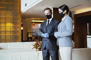 Serious administrator explaining something to the receptionist