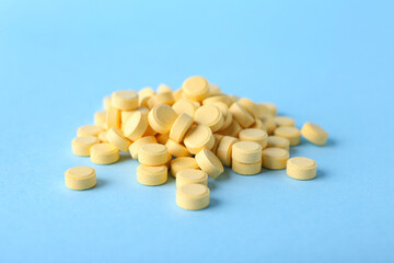 Folic acid pills on color background