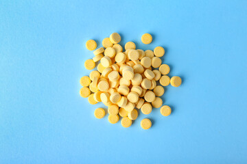 Folic acid pills on color background