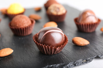 Sweet chocolate candies on light background