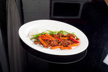 Beef in sweet and sour sauce in a white plate