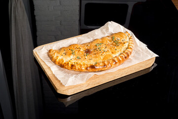 Cooked ringlet served on paper and on a wooden board