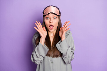 Portrait of attractive amazed scared girl wearing pajama scary spooky news reaction isolated over violet purple color background
