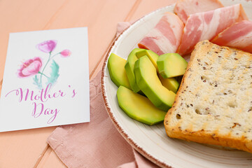 Tasty breakfast for mother on table