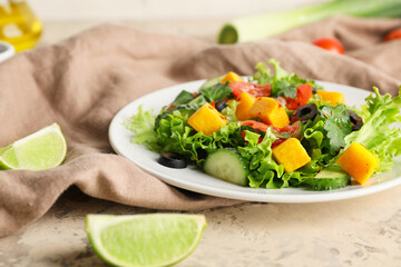 Plate of fresh salad with vegetables on table