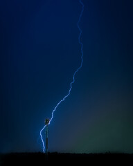 Photo of the lightning in the night sky. Powerful energy, natural electricity. Thunder in the dark,...