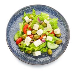 Plate with fresh Greek salad on white background