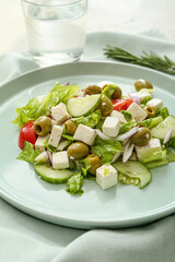 Bowl with fresh Greek salad on table, closeup