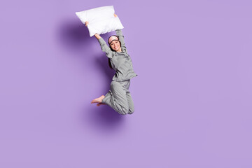 Full length body size photo of girl jumping keeping white pillow in bedroom isolated pastel violet color background