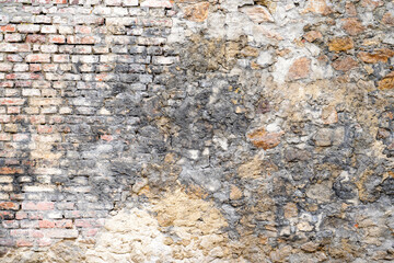 Moldy stone wall through damp walls structure photographed in daylight