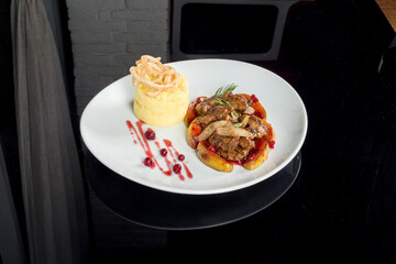 Cooked rabbit liver served in a white plate with garnish