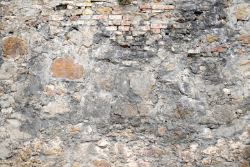 Moldy stone wall through damp walls structure photographed in daylight