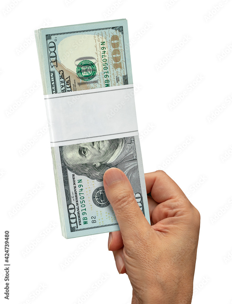 Wall mural Male hand holding a hundred dollar bundle in hand or man giving a hundred bucks dollar bills. Isolated on white background including clipping path. - Wall murals