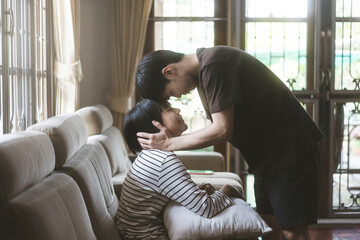 Young adult asian lover couple sitting on sofa cozy style indoor on day.