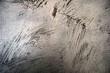 The pattern of the painted wall with silver and gray paint with beautiful strokes