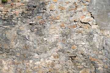 Moldy stone wall through damp walls structure photographed in daylight