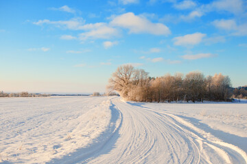 Fototapeta na wymiar Empty snow covered road in winter landscape