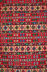 Segment of handmade carpets in bright colors