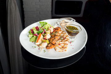 Fish dish prepared in different ways on a white plate