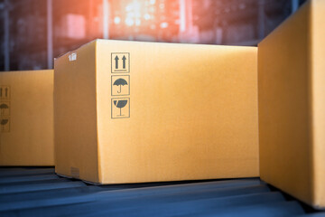 Cardboard Boxes Moving on Rollers Conveyor Belt at Distribution Warehouse. shipment package boxes.
