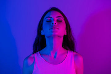 Photo of young stunning gorgeous dreamy woman with closed eyes and messy hair isolated on neon blue color background