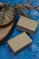 Aleppo soap and dray Laurus nobilis flower in a wooden plate .