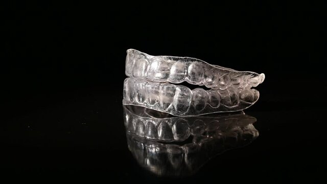 Removable plastic retainers spin against a black background