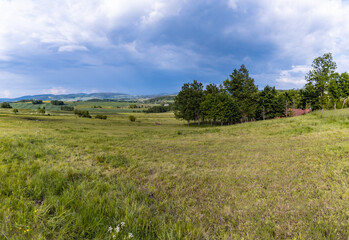 Fototapeta na wymiar Beautiful landscape of green fields and mountains of Rudawy Janowickie