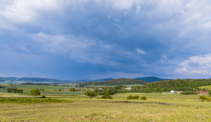 Fototapeta na wymiar Beautiful landscape of green fields and mountains of Rudawy Janowickie