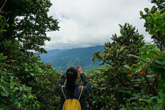 Girl taking picture of the cloud forest in Monteverde, Costa Rica