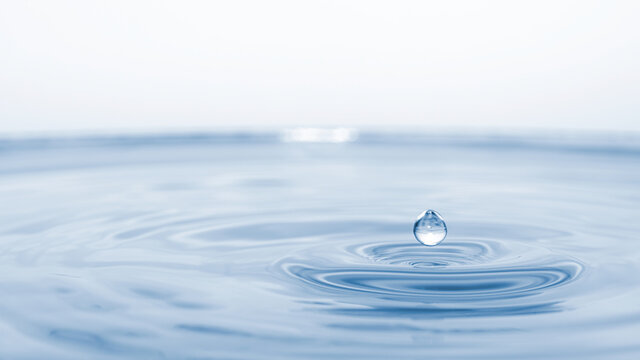 water drop splash in a glass blue colored
