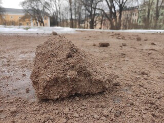 Frozen lump of sand on a slippery slope outside
