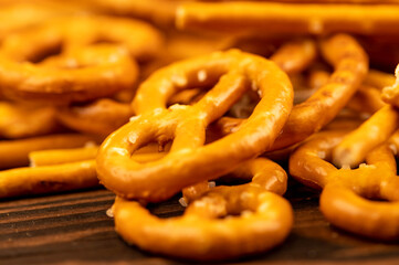 Salted breadsticks and salted pretzels scattered on the table.