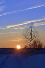 Fototapeta na wymiar Winter sunset on the endless field