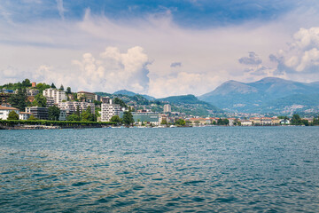 Fototapeta premium Big and modern Swiss city. Lugano city and Lugano lake in a beautiful summer day. Tourist town in southern Switzerland in the Canton of Ticino 