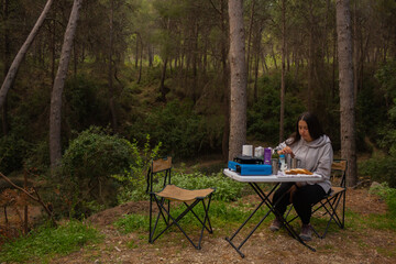 Girl on a camping trip having a glass of milk.