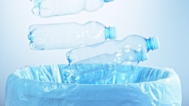 Super Slow Motion Shot of Empty Plastic Bottles Falling Into Trash Can at 1000fps.