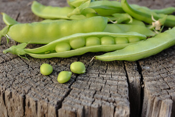 Fresh pods of sweet green peas as natural food summer harvest background. Healthy eating, lifestyle.
