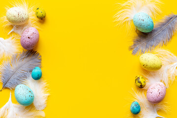 Happy Easter card with colorful eggs and feather. Overhead view