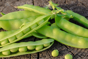 Fresh pods of sweet green peas as natural food summer harvest background. Healthy eating, lifestyle.