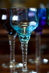 set of colored antique wine glasses with engraving. glass vintage wine glasses