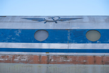 Part of an old plane with round portholes and symbols of civil aviation of the Soviet Union. Copy...
