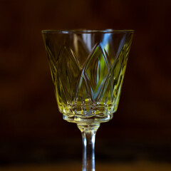 yellow crystal antique engraved shot glass close-up. glass retro shot